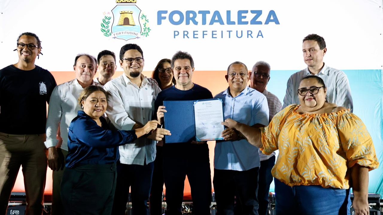 O prefeito Evandro Leitão, gestores da Prefeitura e apoiadores posam para foto com a ordem de serviço da área funcional da Paupina assinada